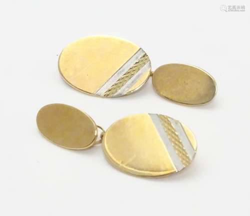 A pair of 9ct gold cufflinks of oval form. Please Note - we do not make reference to the condition