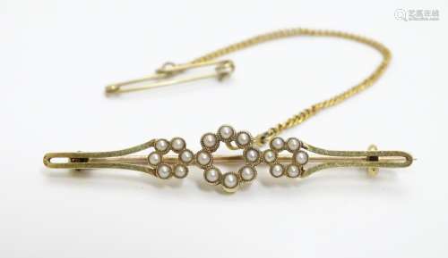A late 19thC / early 20thC 15ct gold brooch set with seed pearls. 1 7/8