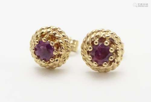 A pair of 9ct stud earring set with red spinel 1/4