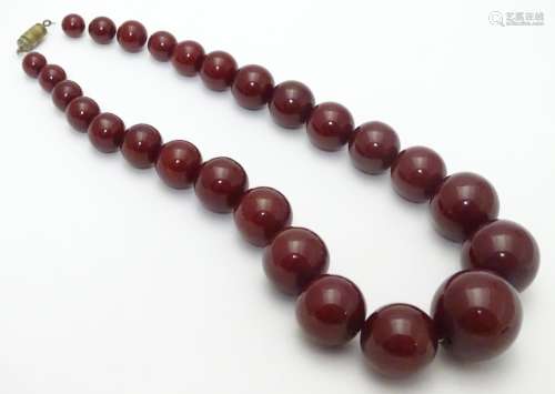 A vintage necklace of graduated cherry amber Bakelite beads. Approx 15