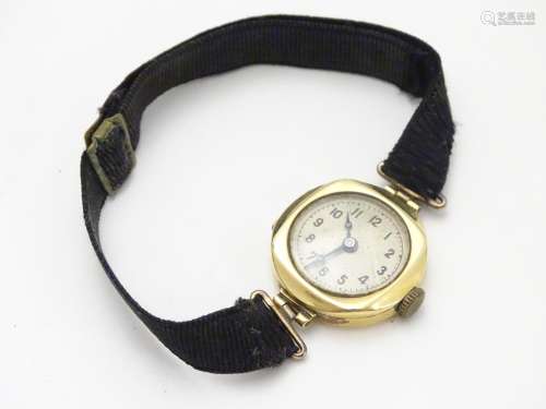 An early 20thC Ladies' wrist watch , with fabric strap and 18ct gold case Please Note - we do not