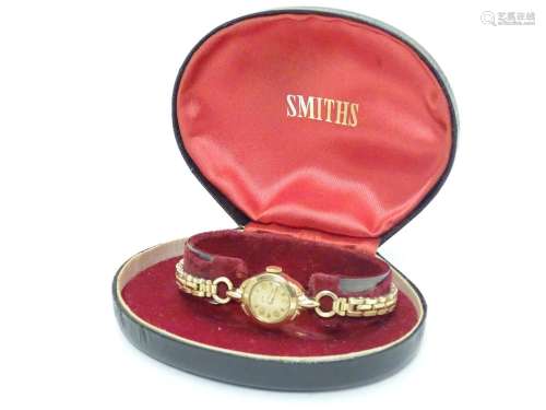 A mid 20thC boxed Smiths ladies' wrist watch, with 9ct gold Dennison case Please Note - we do not