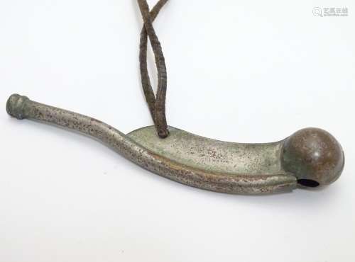 Militaria : an early to mid 20thC Bosun's whistle, with leather lanyard, 4 1/2