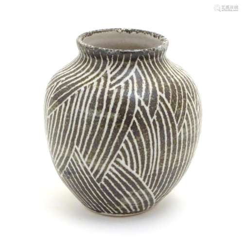 A studio pottery vase of squat baluster form, with monochrome decoration. Incised maker's mark