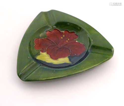 A Moorcroft green ground pin dish / ashtray of triangular form in the Hibiscus pattern. Impressed