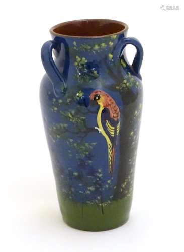 A Longpark Torquay tyg vase with relief parrot decoration and hand painted landscape decoration with