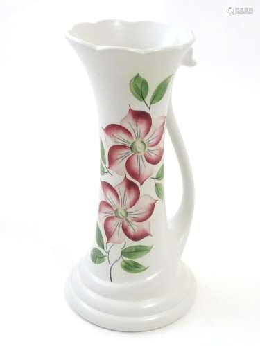 An E Radford hand painted jug / vase with a tendril formed handle and hand painted clematis flower