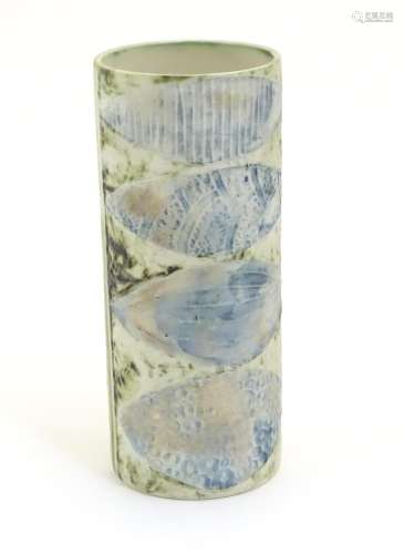 A Cornish Carn Pottery hand built slab vase of cylindrical with abstract leaf formed decoration.