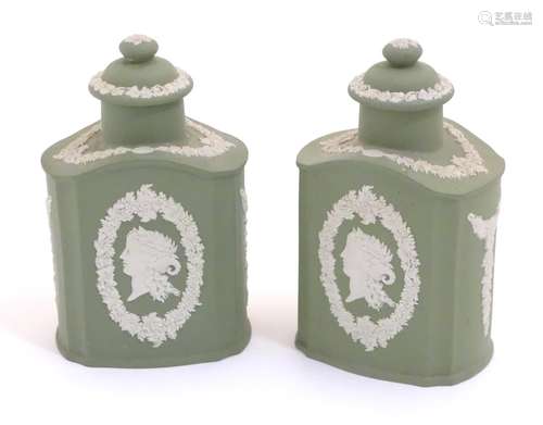 A pair of Wedgwood sage green Jasperware tea caddies and covers, decorated with portrait