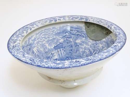 A Victorian water closet bowl / pan with blue and white transfer decoration depicting figures in a