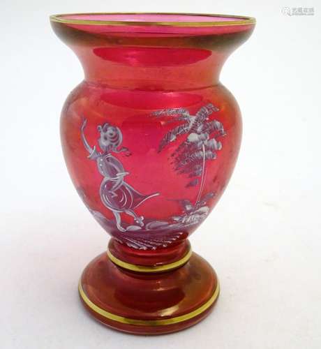 An early 20thC Mary Gregory cranberry glass vase, decorated with an enamelled vignette of girl in