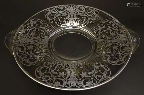 A glass twin handled fruit dish / plate with silvered overlay decoration Approx. 13