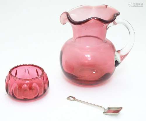 An early 20thC cranberry glass jug, together with a cranberry glass salt and silver plate spoon of
