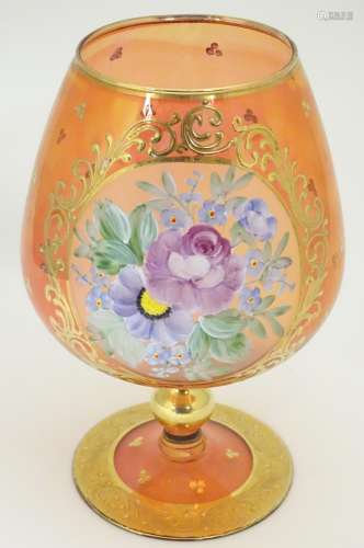 A large Bohemian ruby glass vase shaped like an oversized brandy glass decorated with gold gilt