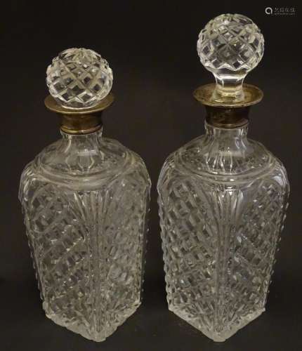 Two cut glass decanters with silver collars. Hallmarked London 1934. Approx 9