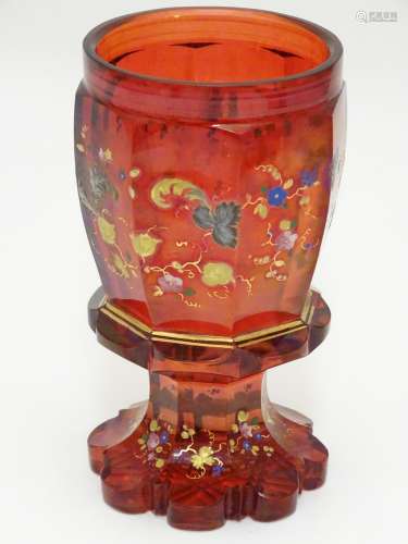 A 19thC bohemian wine glass decorated with floral decoration and gilt highlights. 5 5/8