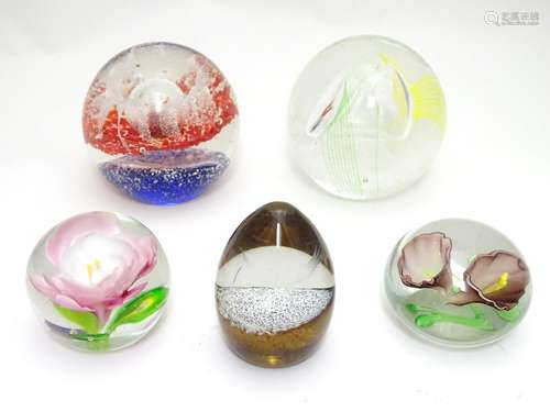 Five art glass paperweights, including an example by Caithness, Scotland formed as a snow capped