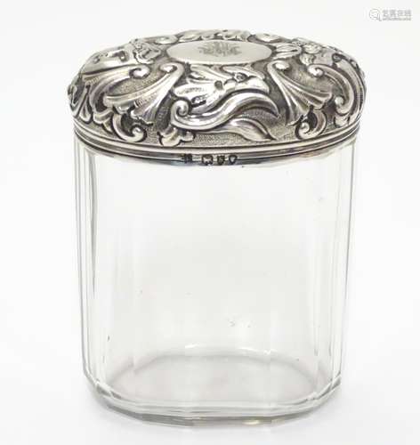 A glass toilet bottle with silver lid hallmarked London 1893 maker Charles Henry Dumenil 3 1/5