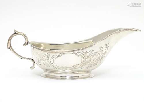 An American Mid 19thC white metal sauce boat with engraved floral and foliate decoration. Bears