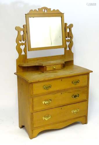 A late 19thC / early 20thC walnut dressing table with a mirror mounted on pierced supports, the base