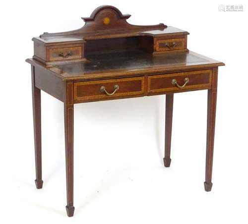 An early 20thC ladies writing desk with marquetry decoration, crossbanded drawers and decorative