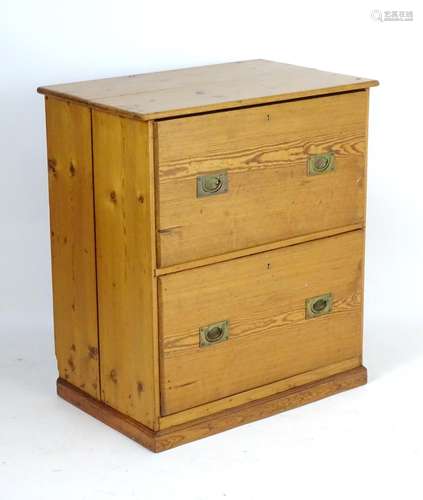 An early 20thC pine two drawer chest with campaign style handles. 33