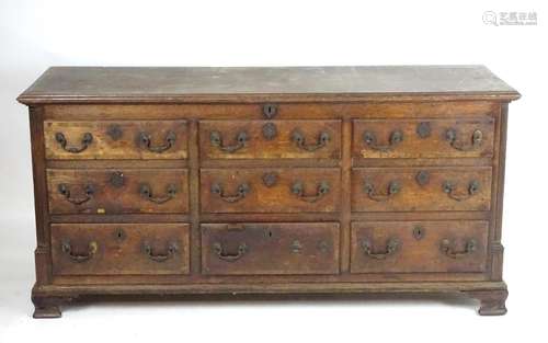 An 18thC oak mule chest with a lifting lid above three short drawers to the base, all the drawer