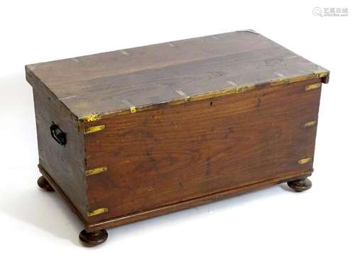 A late 19thC camphor wood military trunk with brass corner brackets, wrought iron carrying handles