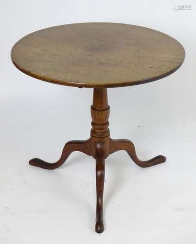 A 19thC oak tripod table with a circular tilt top above a turned stem and three cabriole legs