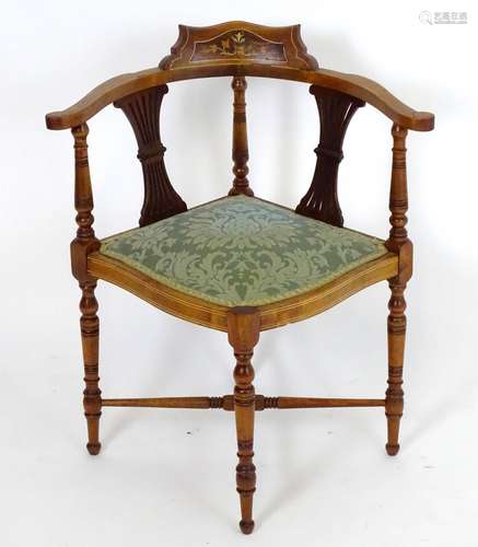 A late 19thC / early 20thC corner chair with a marquetry inlaid cresting rail and decoratively