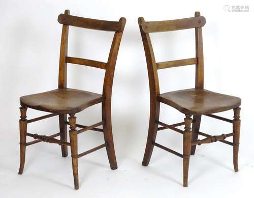 A pair of early 20thC side chairs with pegged chamfered top rails above shaped seats and turned