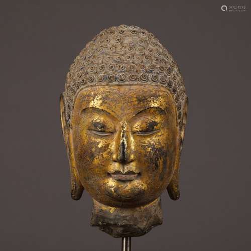 A Stone Buddha Head With Gold Painting