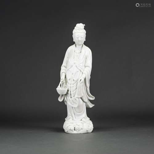 A CHINESE DEHUA GUANYIN HOLDING A BASKET