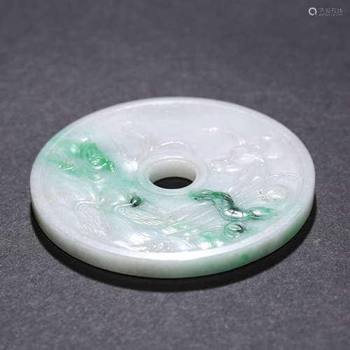 A CARVED JADEITE ‘LOTUS-POND’ PENDANT