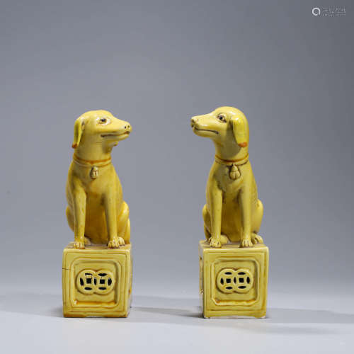 A PAIR OF YELLOW-GLAZED PORCELAIN DOGS