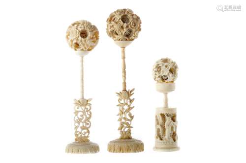 A LOT OF THREE EARLY 20TH CENTURY CHINESE IVORY CONCENTRIC BALLS WITH STANDS