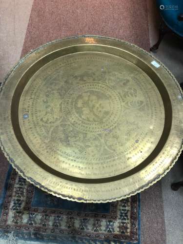 AN EASTERN BRASS TOPPED TABLE