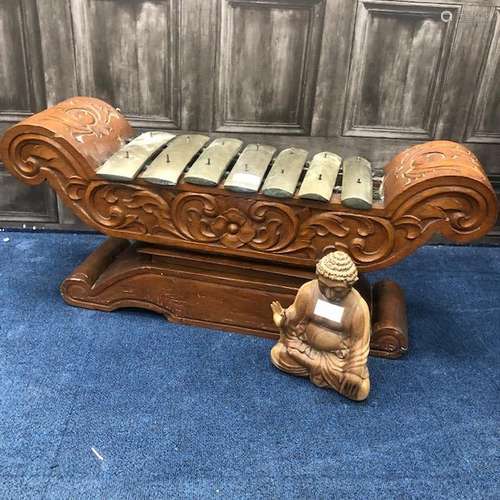 A CARVED WOOD GONG AND A BUDDHA