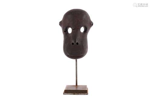 AN AFRICAN POTTERY MODEL OF A MONKEY FACE