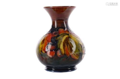 A MOORCROFT LEAF & BERRY PATTERN VASE