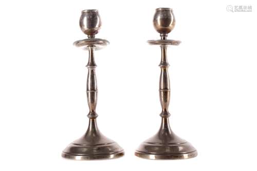 A PAIR OF SILVER CANDLESTICKS