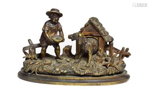 A Bronze Inkwell, late 19th century, cast as a boy feeding a dog in a kennel, 18cm wide