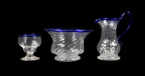 A Matched Glass Cream Jug and Sugar Bowl, circa 1800, of wrythen fluted form with blue glass rims