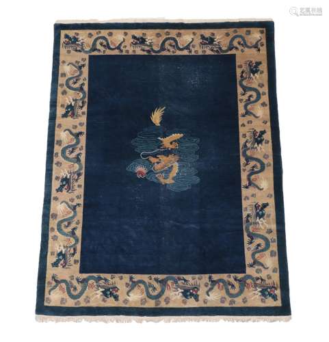 Chinese Carpet, circa 1920 The deep indigo field with central panel containing a dragon enclosed