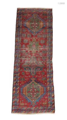 Heriz Runner North West Iran, circa 1900 The madder field with a column of medallions framed by