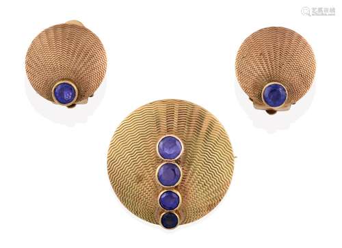 A Sapphire Brooch, of yellow textured circular form with four graduated round cut sapphires in