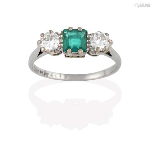 An Emerald and Diamond Three Stone Ring, the central step cut emerald flanked by round brilliant cut