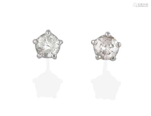 A Pair of Diamond Solitaire Earrings, the round brilliant cut diamonds in white claw settings, total