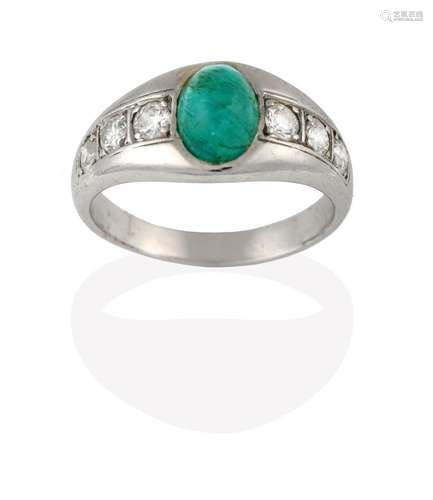 An Emerald and Diamond Ring, the cabochon emerald in a white collet setting, to shoulders inset with