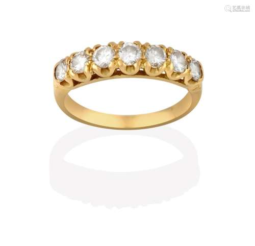 A Diamond Seven Stone Ring, the graduated round brilliant cut diamonds in yellow claw settings, to a